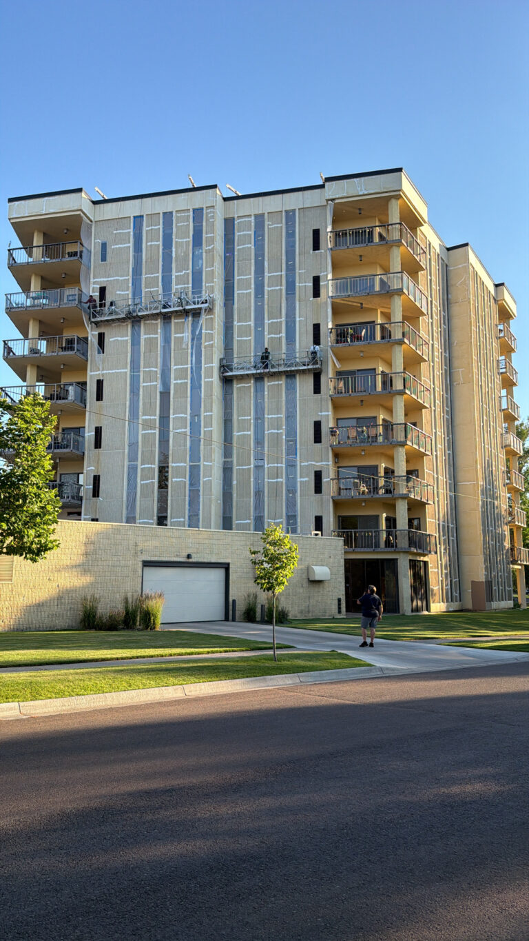 Swing stages on a balcony tower during commercial waterproofing and sealant work