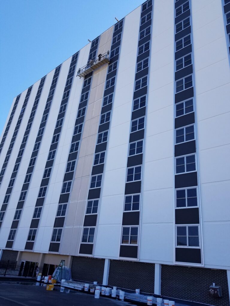 Columns of windows on a high-rise façade where wet glazing seals glass to frame