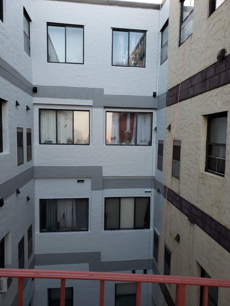 Elastomeric wall coatings on a stucco courtyard wall, beside the uncoated original wall