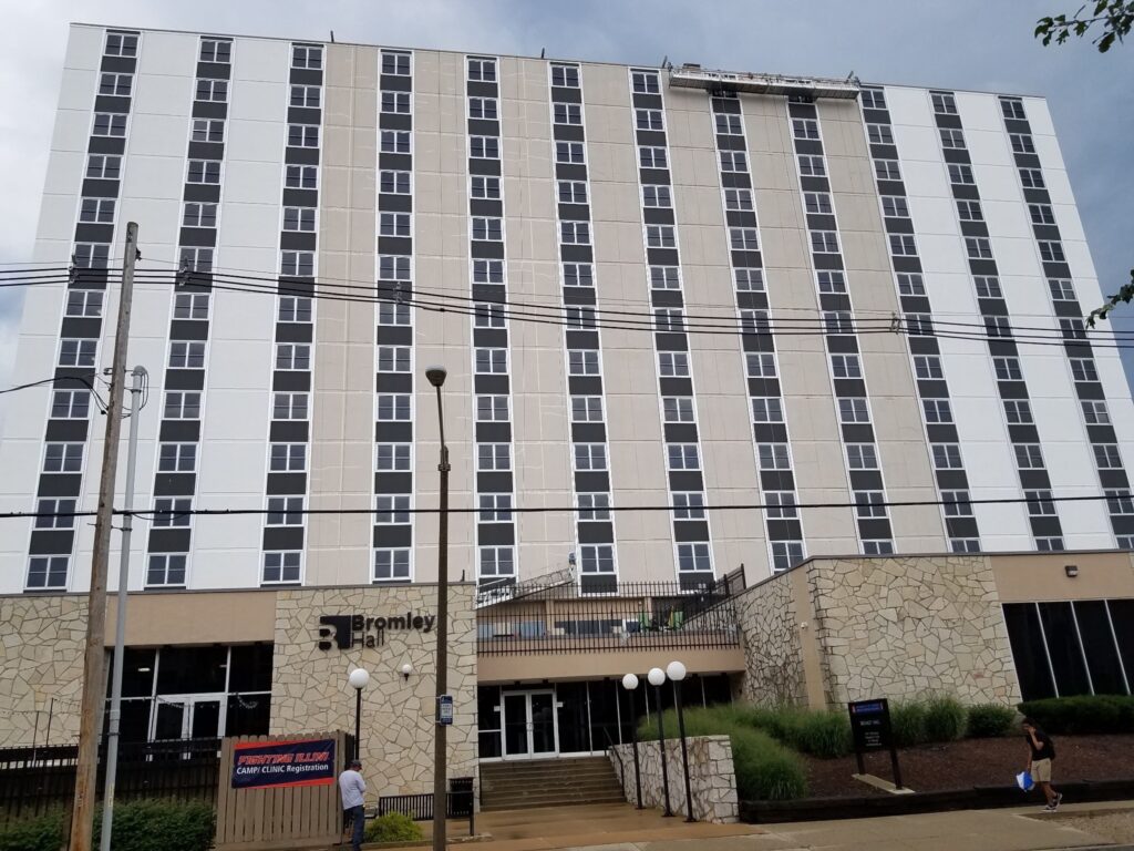 High-rise after commercial exterior painting, with dark window columns