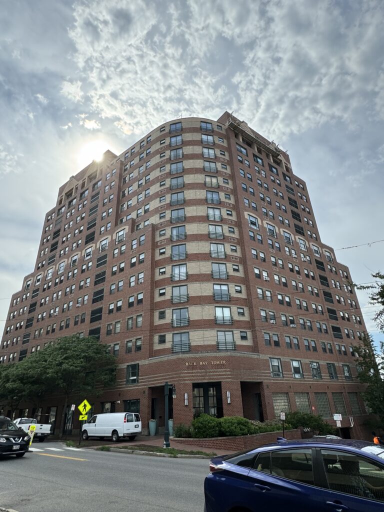 Red and tan banded brick high-rise apartment tower